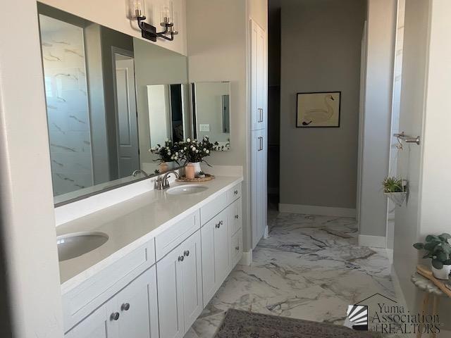 4595 S Villa Serena Drive Model Home Not For Sale, Yuma, AZ 85365 - full bathroom featuring double vanity, baseboards, a sink, and marble finish floor