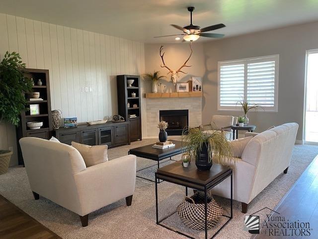 4595 S Villa Serena Drive Model Home Not For Sale, Yuma, AZ 85365 - living room featuring plenty of natural light, ceiling fan, wood finished floors, and a fireplace