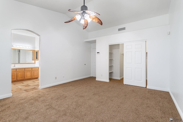 3481 W 27th Ln, Yuma, AZ 85364 - unfurnished bedroom with light colored carpet, a sink, lofted ceiling, baseboards, and connected bathroom