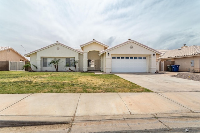 3481 W 27th Ln, Yuma, AZ 85364 - mediterranean / spanish house with stucco siding, an attached garage, driveway, and a tiled roof