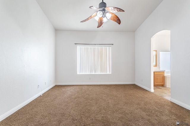 3481 W 27th Ln, Yuma, AZ 85364 - unfurnished room featuring light colored carpet, a ceiling fan, arched walkways, and baseboards