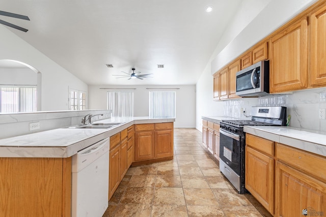 3481 W 27th Ln, Yuma, AZ 85364 - kitchen with appliances with stainless steel finishes, a sink, ceiling fan, light countertops, and tasteful backsplash