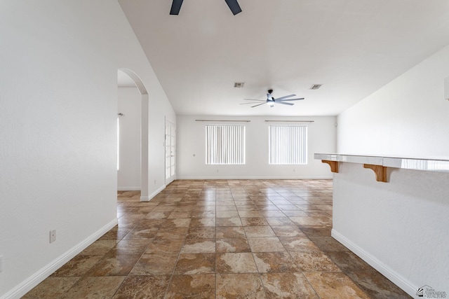 3481 W 27th Ln, Yuma, AZ 85364 - spare room with ceiling fan, arched walkways, baseboards, and light stone finish flooring