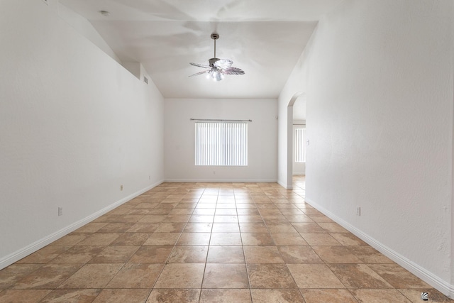 3481 W 27th Ln, Yuma, AZ 85364 - empty room featuring arched walkways, a ceiling fan, and baseboards