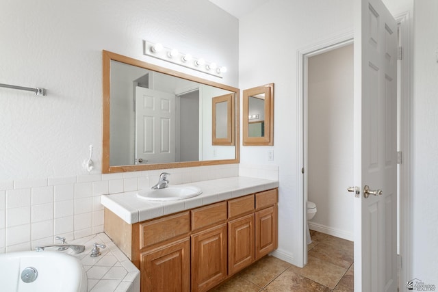 3481 W 27th Ln, Yuma, AZ 85364 - full bathroom with vanity, a garden tub, toilet, and tile patterned flooring