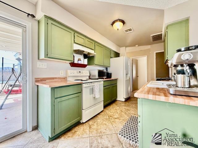 kitchen with under cabinet range hood, visible vents, white appliances, and green cabinets