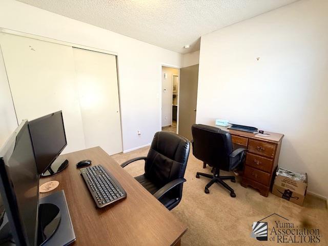 office space featuring carpet and a textured ceiling