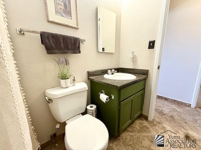 bathroom with toilet and vanity