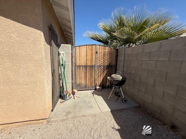 view of patio / terrace featuring a gate and fence