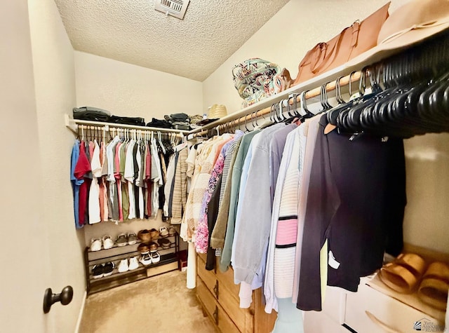 walk in closet featuring visible vents and carpet floors