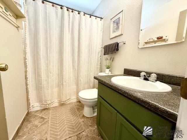 bathroom with vanity, toilet, and tile patterned flooring