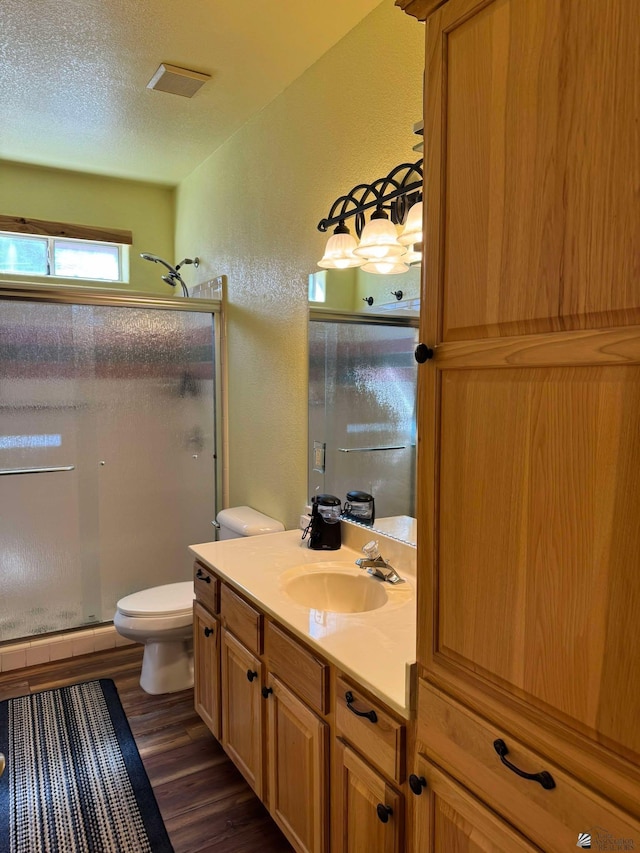 14453 E 55th St, Yuma, AZ 85367 - full bath featuring toilet, visible vents, wood finished floors, and a stall shower