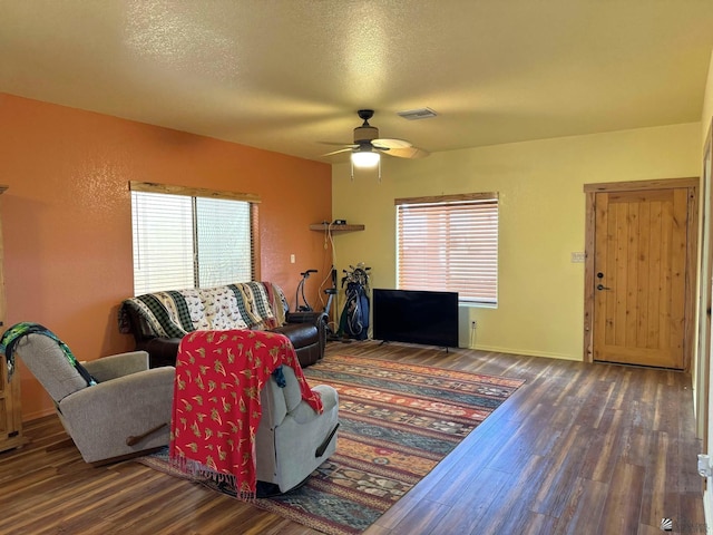 14453 E 55th St, Yuma, AZ 85367 - living room featuring plenty of natural light, a ceiling fan, wood finished floors, and visible vents