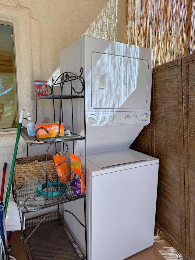 14453 E 55th St, Yuma, AZ 85367 - laundry area featuring stacked washing maching and dryer, tile patterned flooring, laundry area, and a textured wall