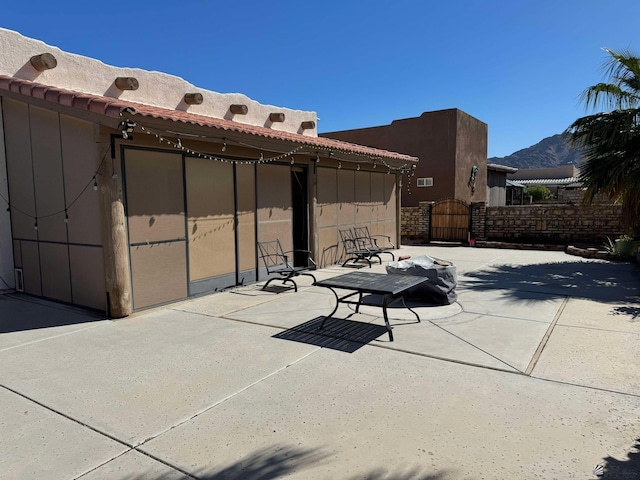 14453 E 55th St, Yuma, AZ 85367 - view of patio / terrace with fence, a gate, and a mountain view