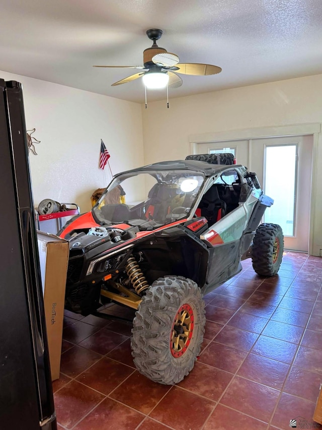 14453 E 55th St, Yuma, AZ 85367 - garage with ceiling fan and freestanding refrigerator