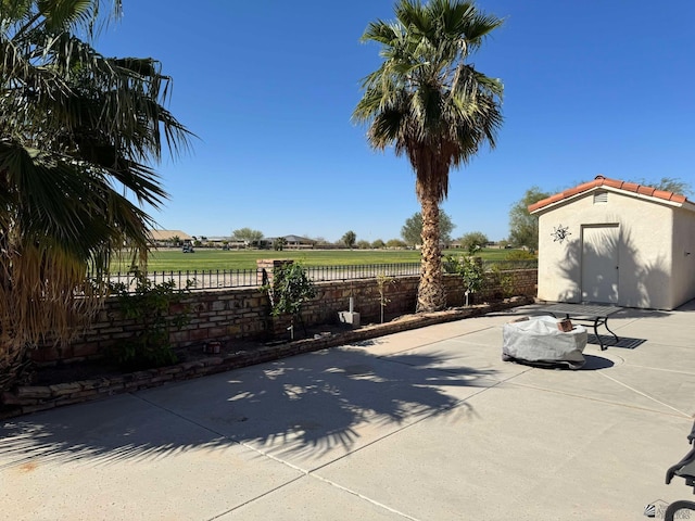 14453 E 55th St, Yuma, AZ 85367 - view of patio / terrace featuring a storage shed, fence, and an outbuilding