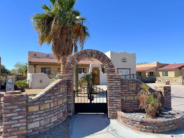 14453 E 55th St, Yuma, AZ 85367 - mediterranean / spanish home with fence private yard, a gate, and stucco siding