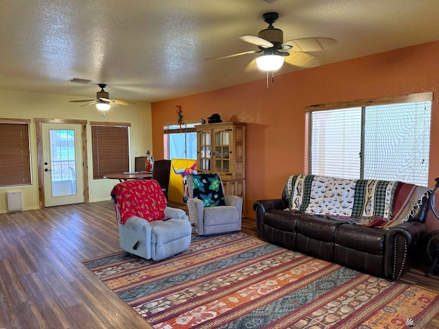 14453 E 55th St, Yuma, AZ 85367 - living room featuring ceiling fan, a textured ceiling, visible vents, wood finished floors, and baseboards