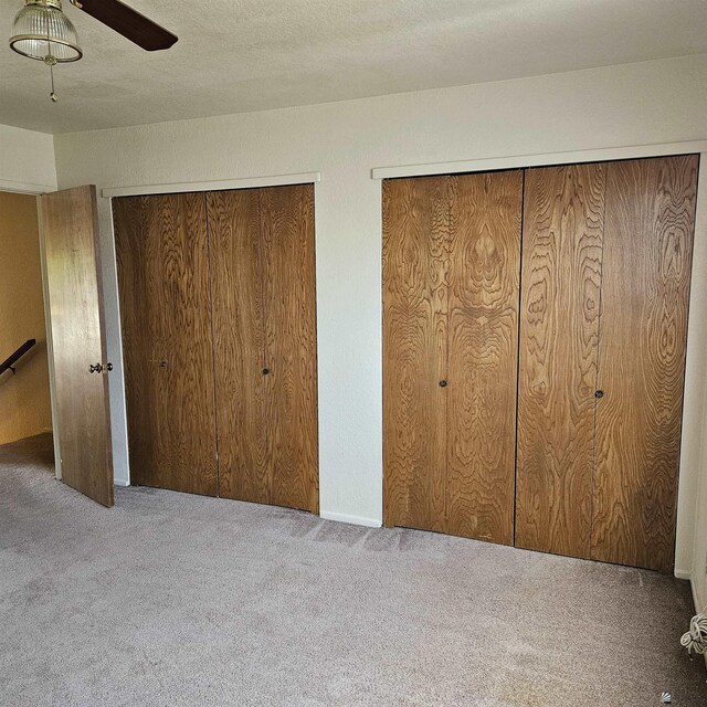 2901 S Palo Verde Ln # 48, Yuma, AZ 85365 - unfurnished bedroom featuring carpet floors, ceiling fan, and multiple closets