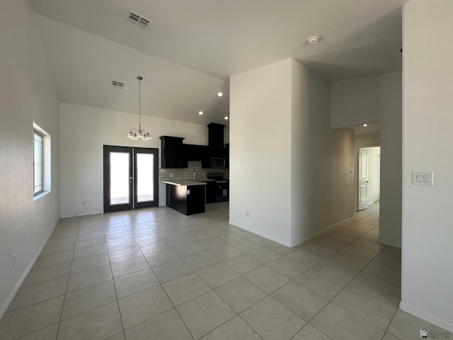 10744 E 45th Pl, Yuma, AZ 85367 - unfurnished living room with light tile patterned floors, high vaulted ceiling, baseboards, a chandelier, and french doors