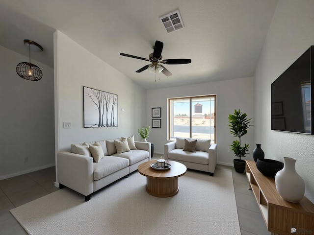10744 E 45th Pl, Yuma, AZ 85367 - living room with light tile patterned floors, a ceiling fan, lofted ceiling, and baseboards