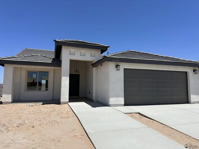 10744 E 45th Pl, Yuma, AZ 85367 - prairie-style home featuring stucco siding, a tiled roof, and an attached garage