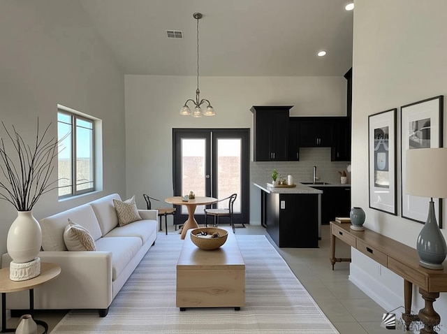 10744 E 45th Pl, Yuma, AZ 85367 - living room featuring plenty of natural light, light tile patterned flooring, a towering ceiling, a chandelier, and recessed lighting