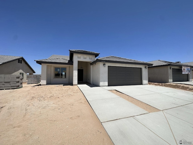 10744 E 45th Pl, Yuma, AZ 85367 - prairie-style home featuring a garage, stucco siding, driveway, and a tile roof