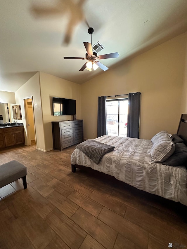 bedroom with ceiling fan, hardwood / wood-style floors, and vaulted ceiling