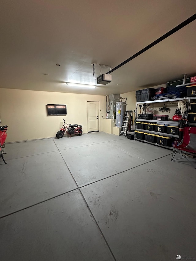 garage featuring strapped water heater and a garage door opener