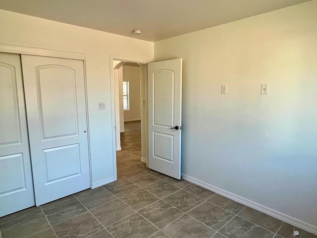 29861 E Vista Ridge Blvd, Wellton, AZ 85356 - unfurnished bedroom with a closet, arched walkways, and baseboards