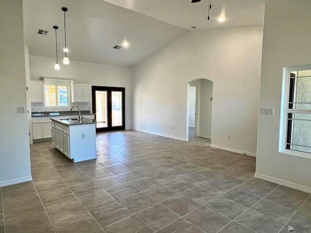 29861 E Vista Ridge Blvd, Wellton, AZ 85356 - kitchen featuring dark countertops, a sink, arched walkways, high vaulted ceiling, and visible vents