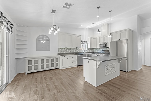 11637 E 27th St, Yuma, AZ 85367 - kitchen with visible vents, dark countertops, appliances with stainless steel finishes, tasteful backsplash, and light wood finished floors