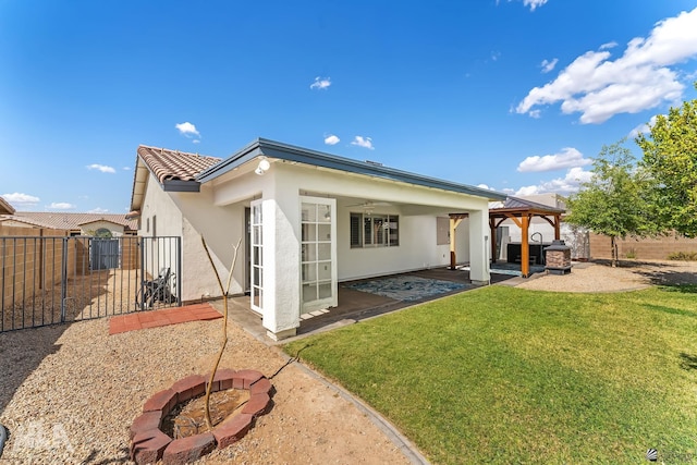 11637 E 27th St, Yuma, AZ 85367 - back of house featuring a patio, a fenced backyard, stucco siding, a gazebo, and a lawn