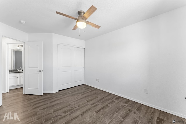 11637 E 27th St, Yuma, AZ 85367 - unfurnished bedroom featuring baseboards, ceiling fan, dark wood-style floors, and a closet