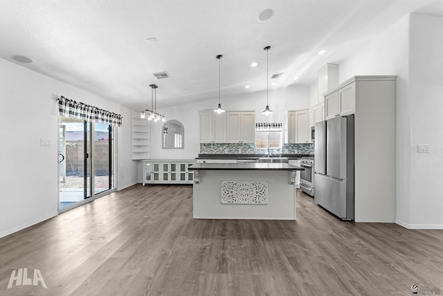 11637 E 27th St, Yuma, AZ 85367 - kitchen with stainless steel appliances, dark countertops, visible vents, and wood finished floors