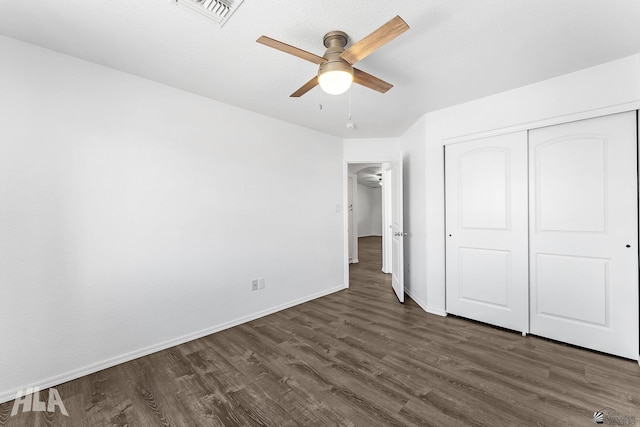 11637 E 27th St, Yuma, AZ 85367 - unfurnished bedroom featuring visible vents, dark wood finished floors, baseboards, and a closet