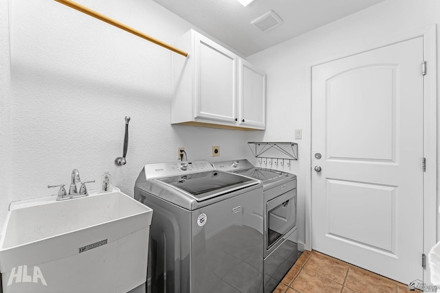 11637 E 27th St, Yuma, AZ 85367 - laundry area with visible vents, washing machine and dryer, cabinet space, a sink, and light tile patterned floors