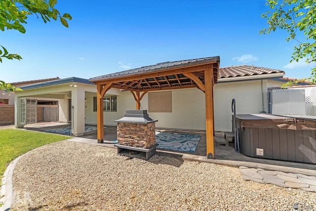 11637 E 27th St, Yuma, AZ 85367 - back of property with a patio area, a hot tub, a gazebo, fence, and stucco siding