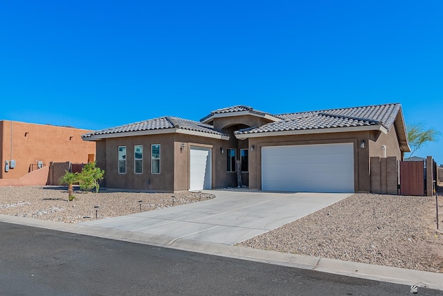 14769 E 47th Ln, Yuma, AZ 85367 - view of front of home featuring an attached garage, a tile roof, stucco siding, and concrete driveway