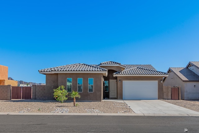14769 E 47th Ln, Yuma, AZ 85367 - view of front of house featuring a tile roof, a garage, fence, and concrete driveway