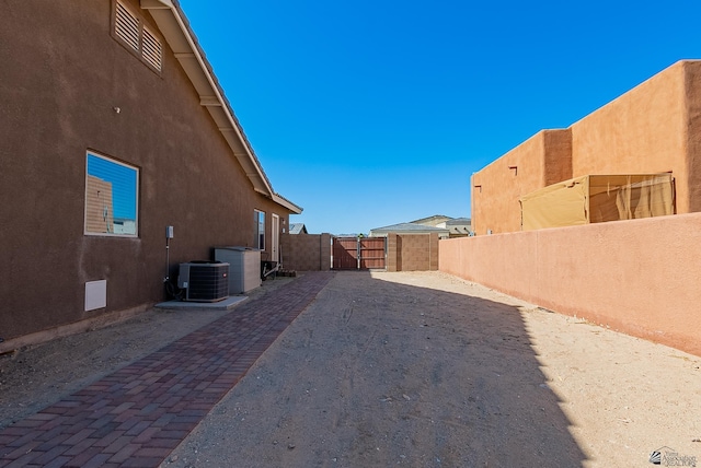 14769 E 47th Ln, Yuma, AZ 85367 - view of property exterior with stucco siding, a gate, a fenced backyard, and cooling unit