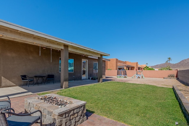14769 E 47th Ln, Yuma, AZ 85367 - view of yard featuring a patio, a fire pit, and a playground