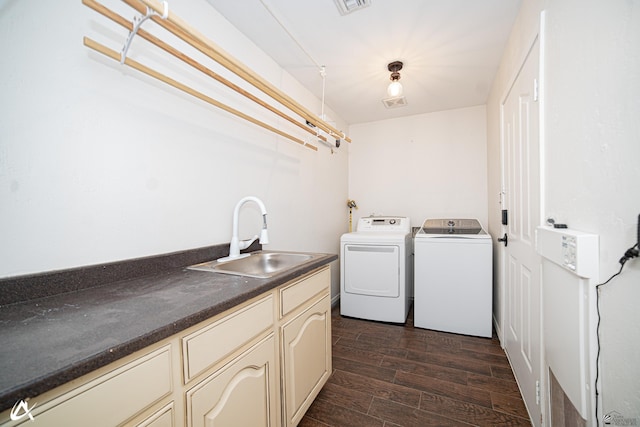 2864 W 12th Ln, Yuma, AZ 85364 - laundry area featuring washing machine and dryer, dark wood finished floors, and cabinet space