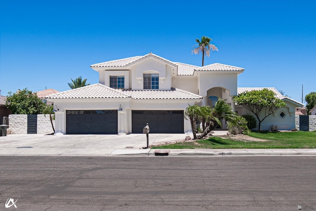 2864 W 12th Ln, Yuma, AZ 85364 - mediterranean / spanish-style house featuring a tile roof, concrete driveway, stucco siding, and a garage