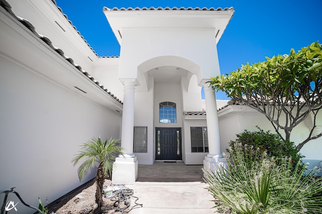 2864 W 12th Ln, Yuma, AZ 85364 - doorway to property with a tile roof and stucco siding