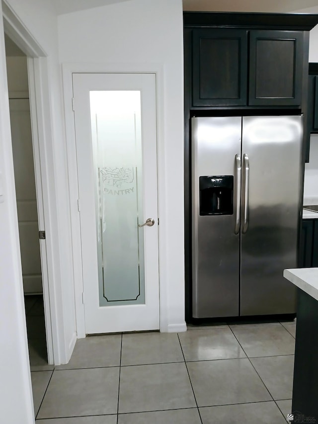 kitchen featuring light countertops, stainless steel refrigerator with ice dispenser, and light tile patterned floors