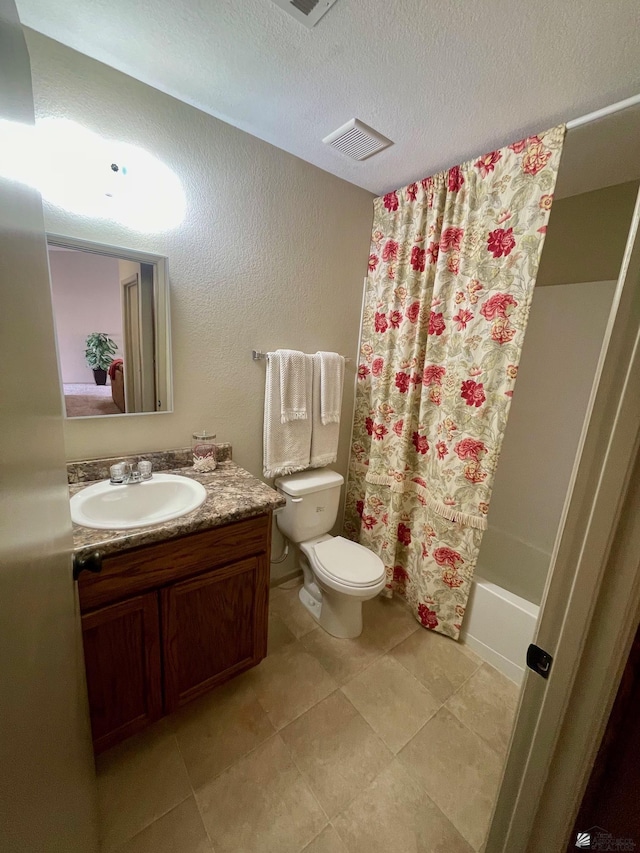 full bathroom with a textured wall, vanity, toilet, a textured ceiling, and visible vents