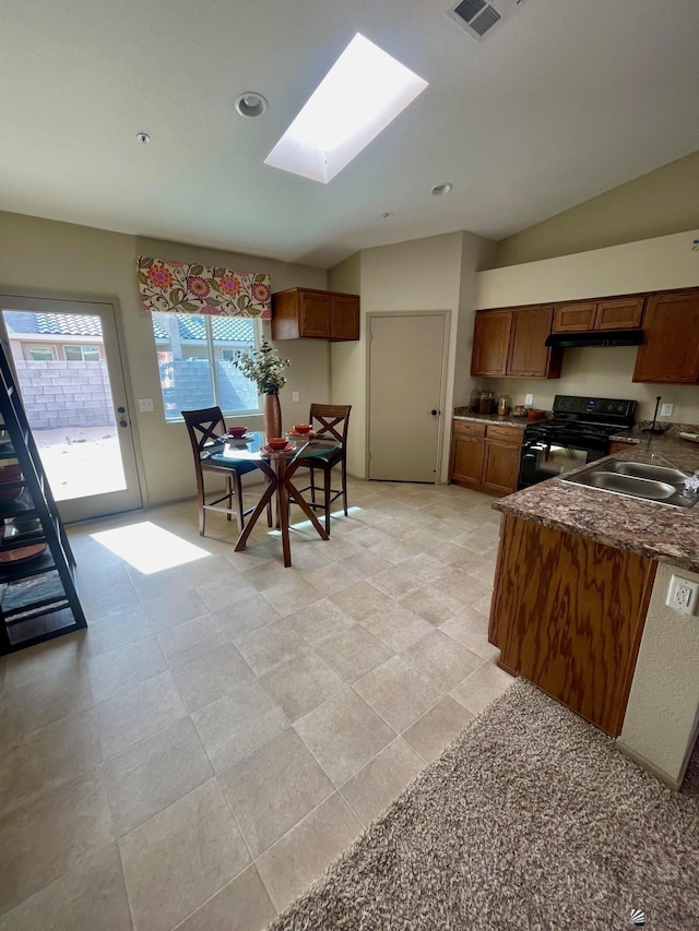kitchen featuring a sink, a skylight, black electric range oven, and brown cabinetry